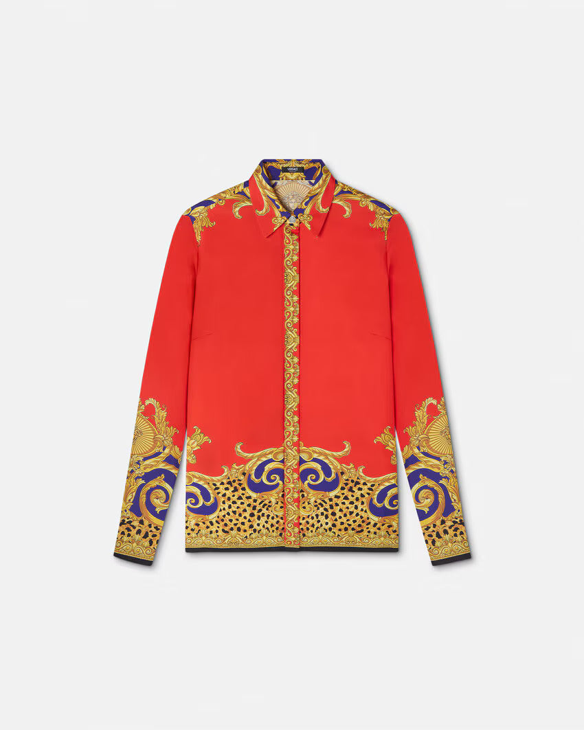 Red silk shirt with gold and purple baroque print on a white background.