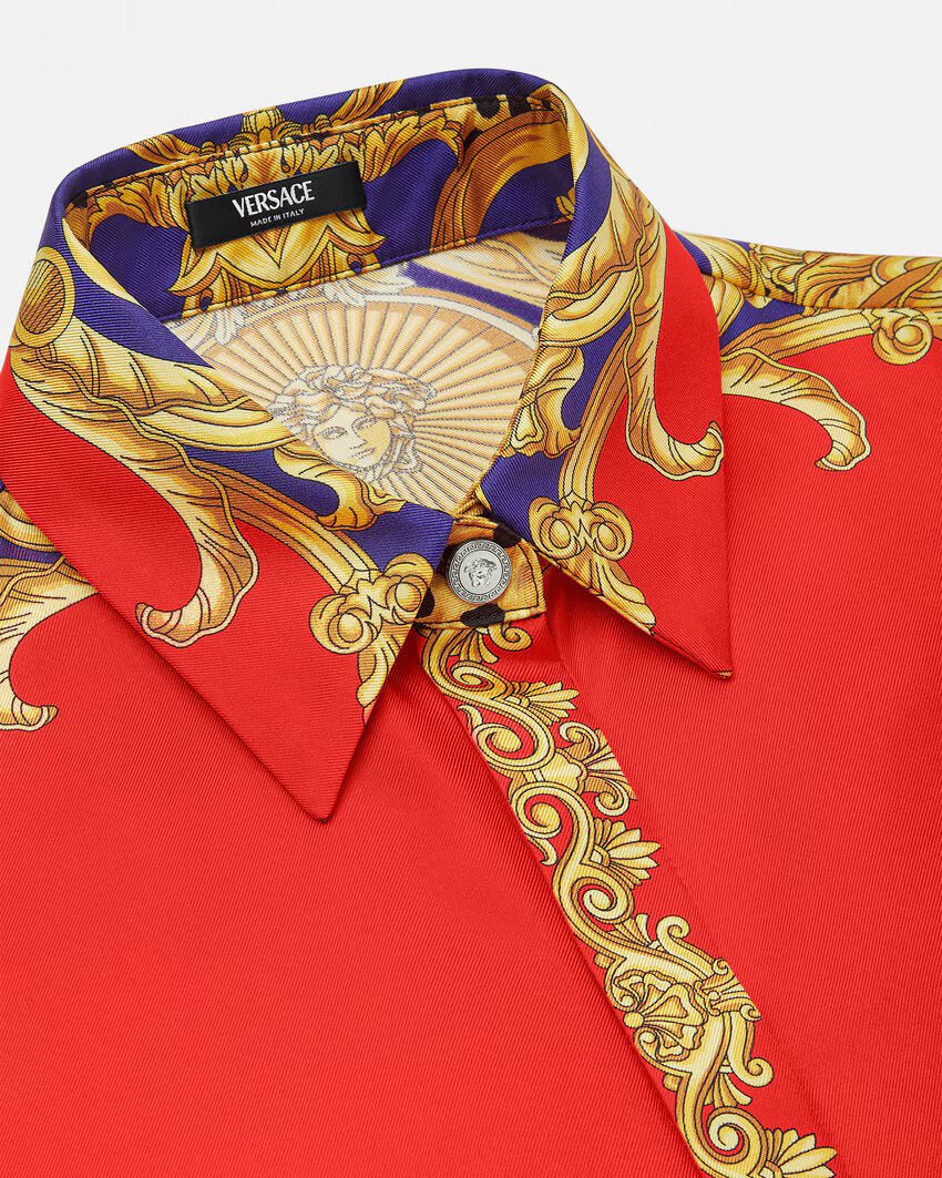 Red silk VERSACE shirt with gold and purple baroque print on a white background.