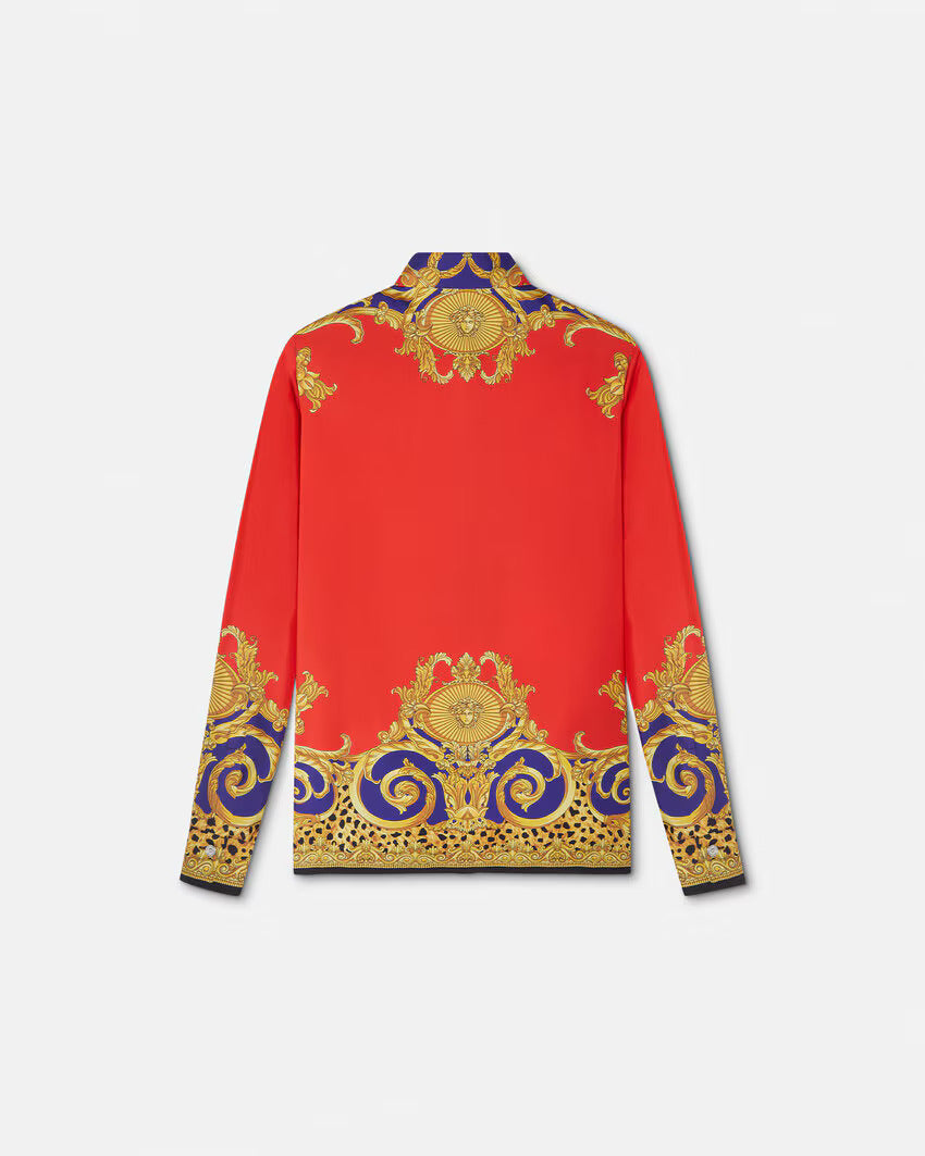Back of red silk VERSACE shirt with gold and purple baroque print on a white background.
