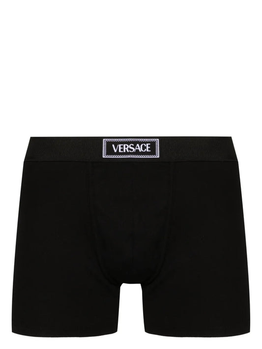 Black Versace boxer briefs on a white background.