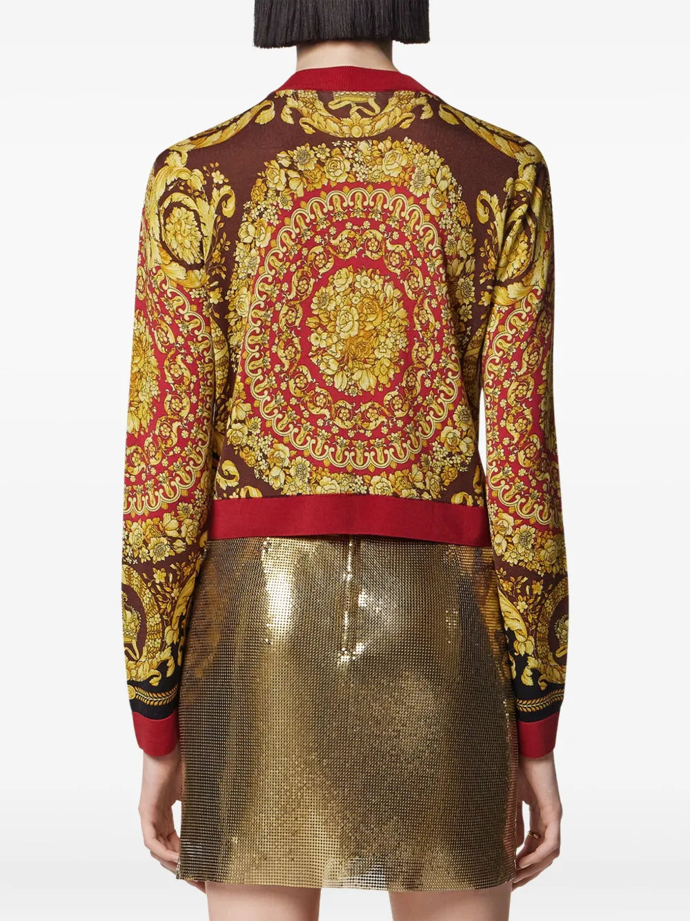 Gold and red barocco cardigan sweater with a gold skirt on a white background