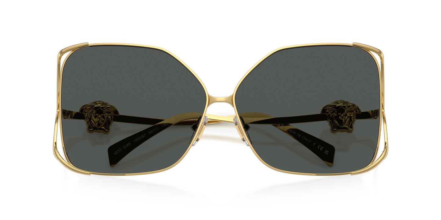 Gold-framed Versace sunglasses with Medusa on the temples.