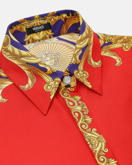 Red silk VERSACE shirt with gold and purple baroque print on a white background.