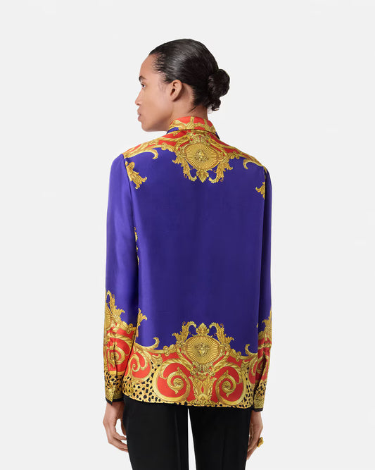 Model wearing a purple silk blouse with a baroque and cheetah print on a white background.