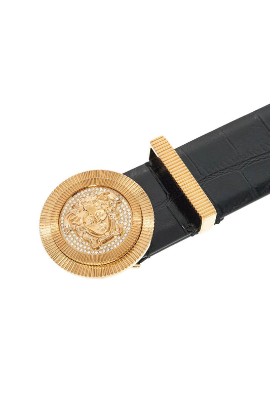 Black croc embossed leather belt with gold Medusa buckle on a white background.