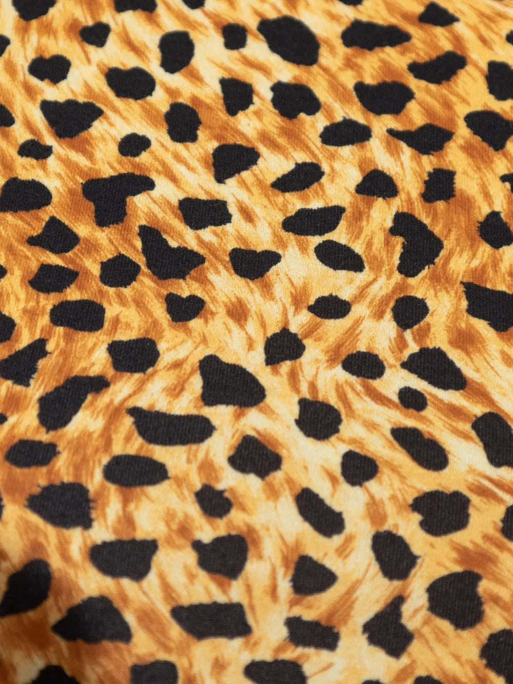 Close-up of fabric with a cheetah print pattern.