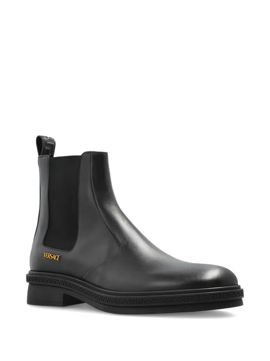 Black Versace Chelsea boot on a white background.