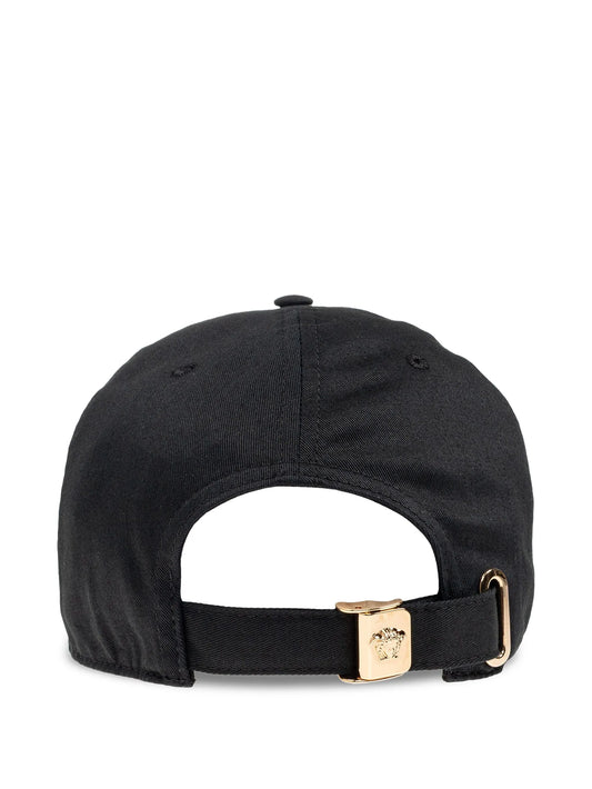 Black cap with a gold adjustable strap on a white background.