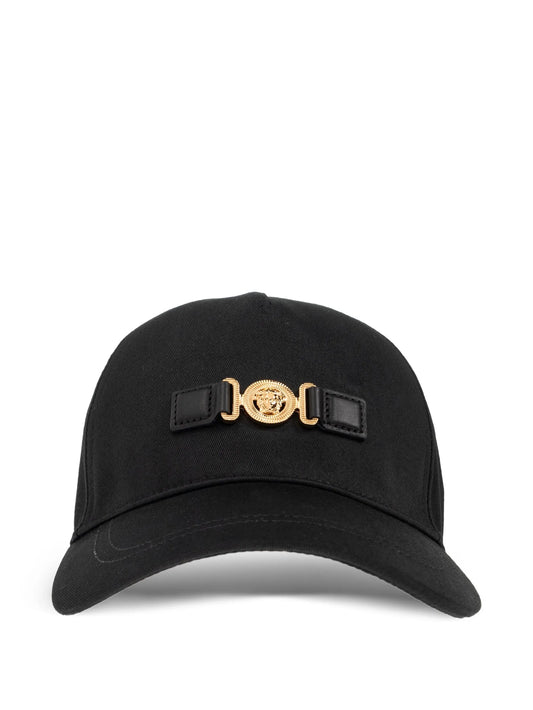Black cap with a gold and black emblem on a white background.