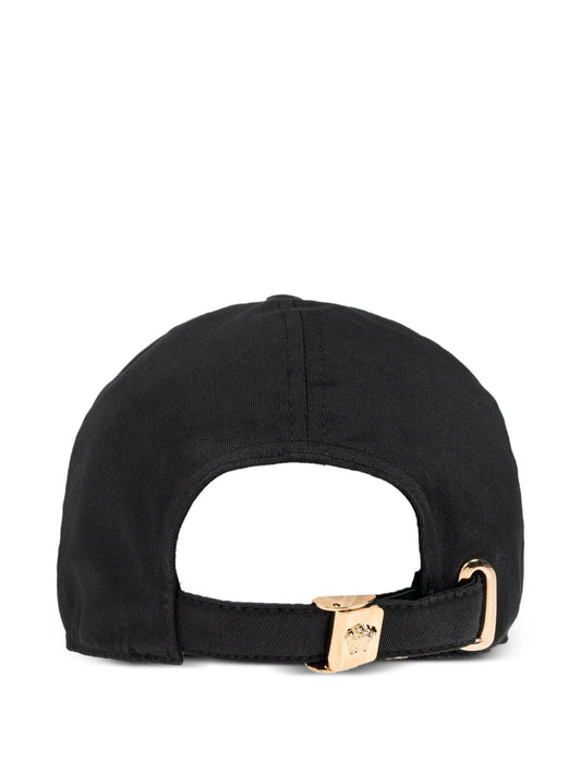 Black cap with a gold buckle on a white background.