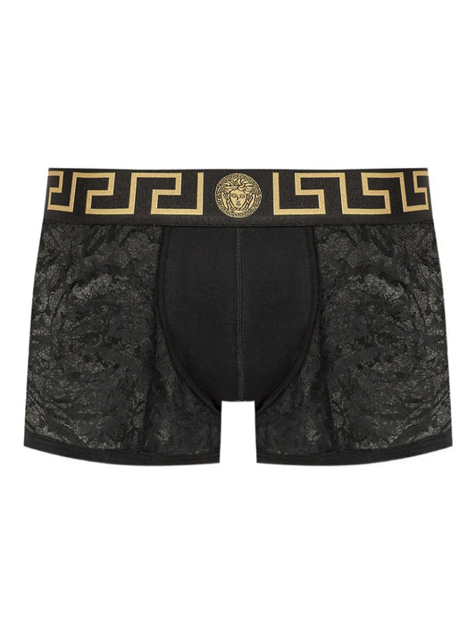 Black lace boxer briefs with gold waistband featuring a logo on a white background