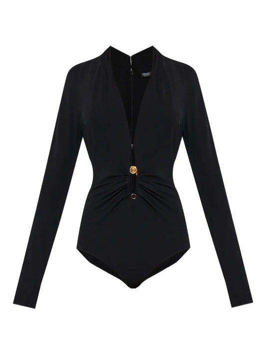 Black long-sleeve bodysuit with a gold safety pin on a white background.
