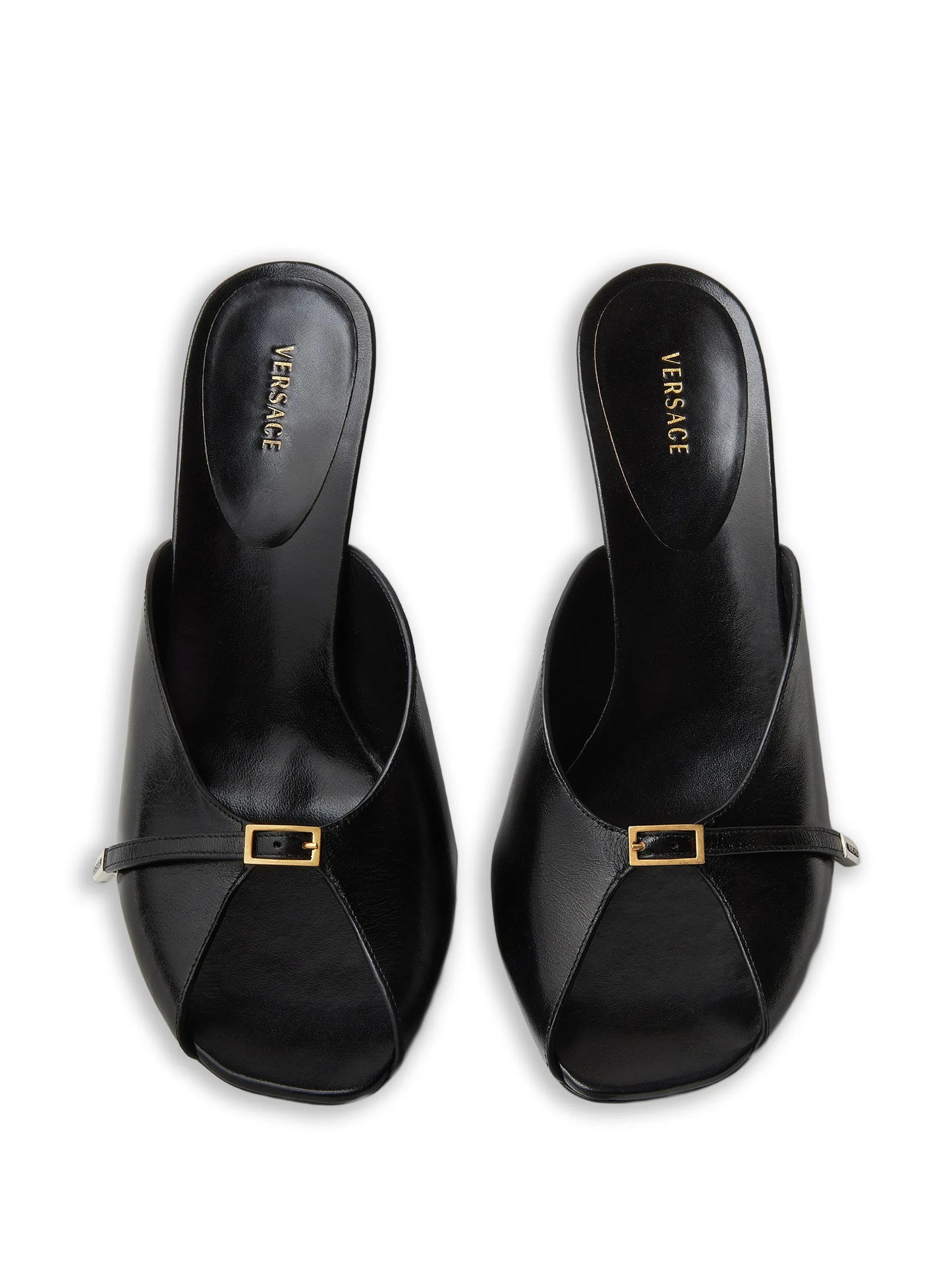 Black Versace sandals with gold buckles on a white background.