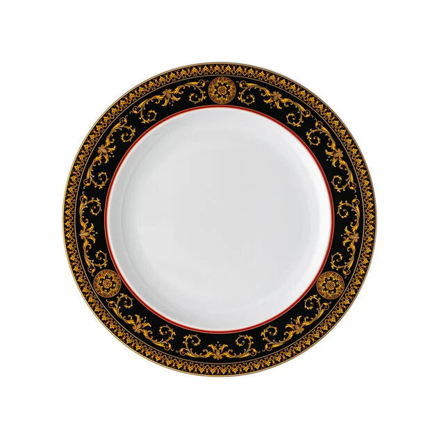 Decorative plate with black and gold border on a white background