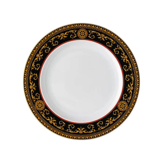 Decorative plate with black and gold border on a white background