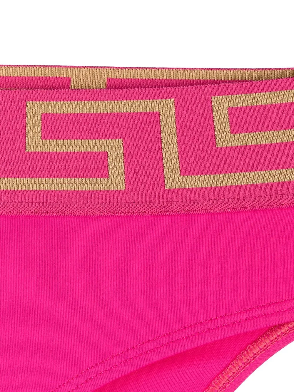 Bright pink Versace bikini bottom with a gold Greek key pattern along the waistband, shown in a close-up studio shot.